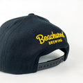Beachwood "B" Snapback in Black with Black and Yellow embroidery.