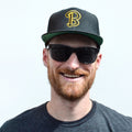 Beachwood "B" Snapback in Black with Black and Yellow embroidery.